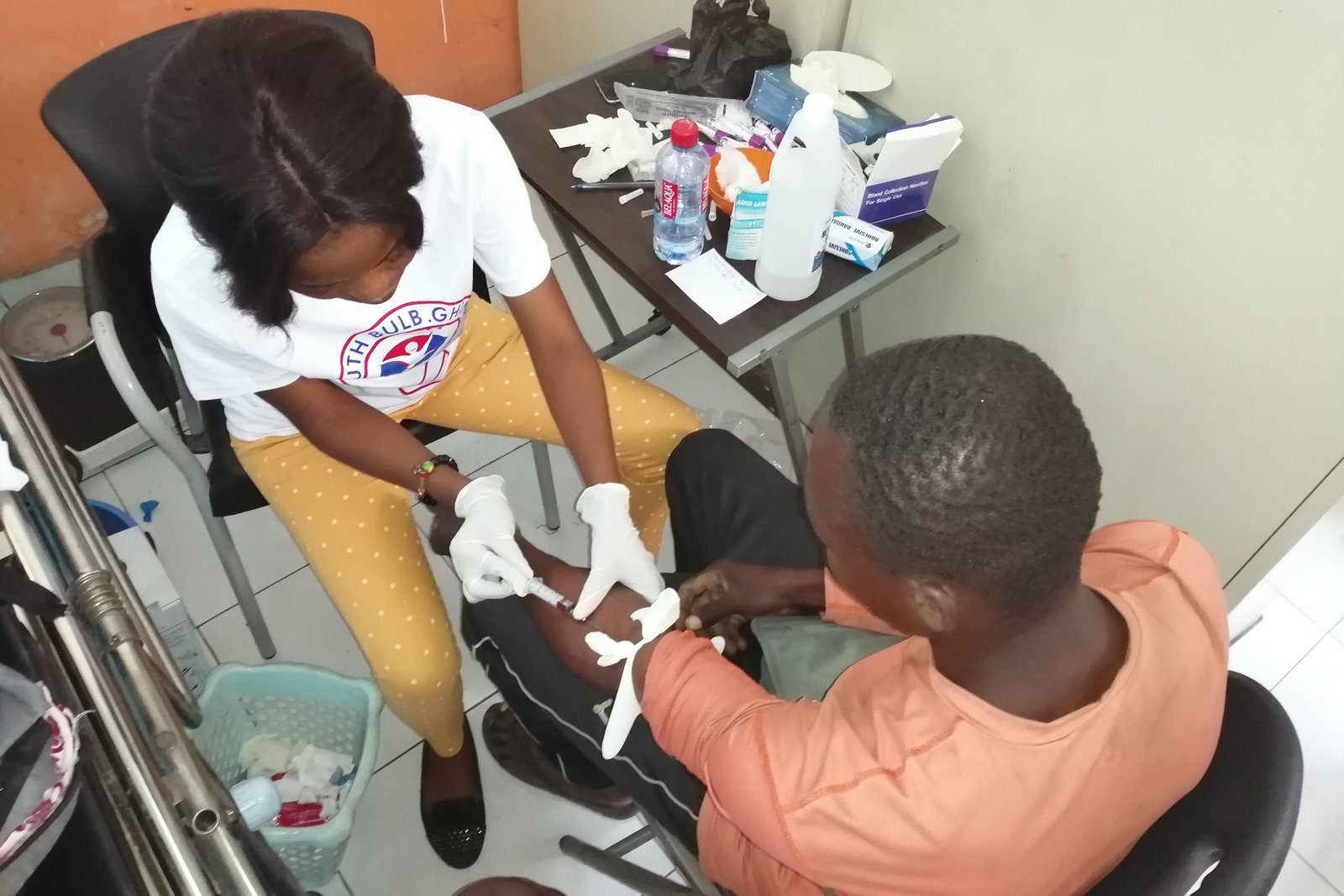 A health worker taking a blood sample