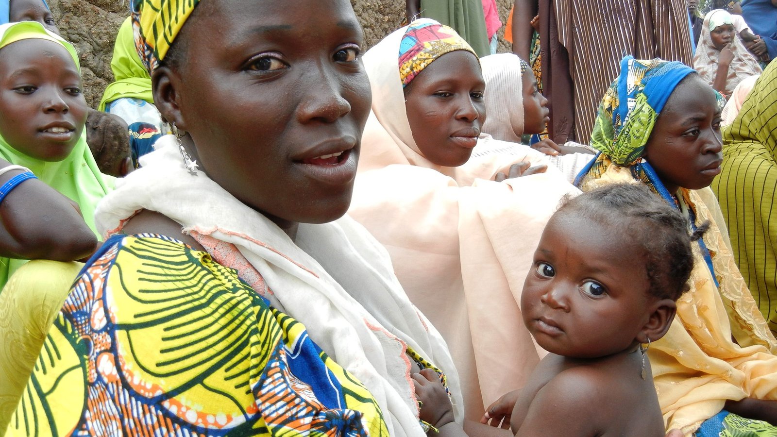 Nigerian women and children at an NNKF community health gathering